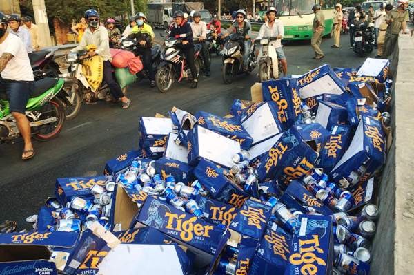 Người dân giúp tài xế thu dọn hàng trăm thùng bia đổ xuống đường ảnh 2